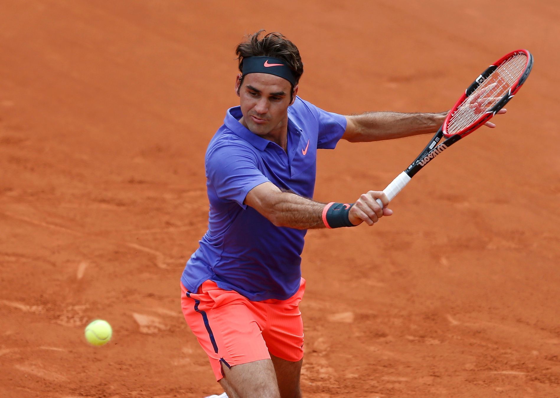 Roger Federer of Switzerland plays a shot to Alejandro Falla of Colombia during their men's singles match at the French Open tennis tournament at the Roland Garros stadium in Paris