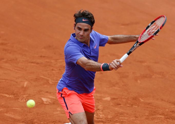 Roger Federer of Switzerland plays a shot to Alejandro Falla of Colombia during their men's singles match at the French Open tennis tournament at the Roland Garros stadiu