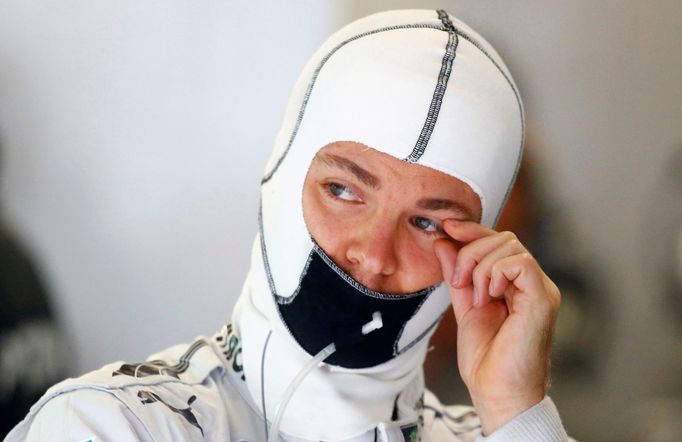 Mercedes Formula One driver Nico Rosberg of Germany wipes his eye during the first practice session of the German F1 Grand Prix at the Nuerburgring racing circuit, July 5