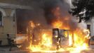 A man attempts to extinguish a burning vehicle during clashes with riot police near Independence Square in Kiev February 20, 2014. Ukrainian protesters hurling petrol bom