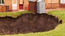 A massive hole opens up in a back garden in Egremont Cumbria as a result of mining subsidence when i