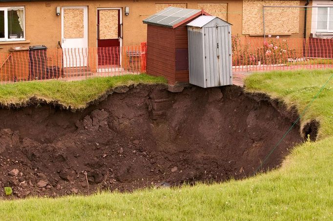 A massive hole opens up in a back garden in Egremont Cumbria as a result of mining subsidence when i