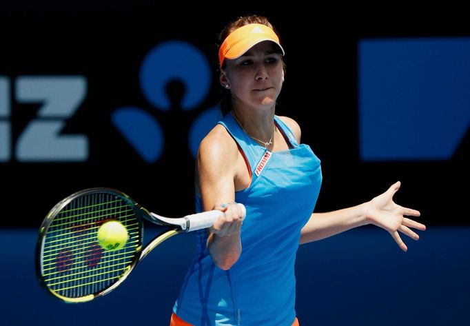 Belinda Bencic of Switzerland hits a return to Li Na of China during their women's singles match at the Australian Open 2014 tennis tournament in Melbourne January 15, 20