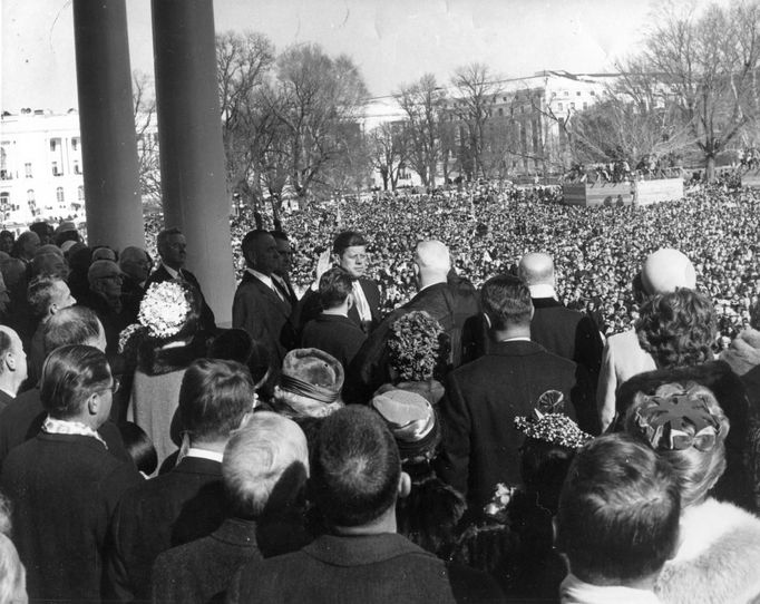 Former U.S. Supreme Court Chief Justice Earl Warren (C) administers the oath of office to former President John F. Kennedy (center-left) during inauguration ceremonies at the Capitol in Washington, in this handout photograph taken on January 20, 1961.