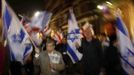 Pro-Israel demonstrators hold Israeli flags during a protest outside Israel's embassy in central London November 15, 2012. Israeli aircraft attacked targets throughout the Gaza Strip on Thursday night, unleashing dozens of strikes in swift succession according to Reuters witnesses. The airstrikes marked an escalation of two days of reciprocal attacks between the Palestinian militant Hamas group ensconced in the coastal enclave and the Israeli military, which killed a top Islamist leader on Wednesday. REUTERS/Stefan Wermuth (BRITAIN - Tags: SOCIETY POLITICS CIVIL UNREST) Published: Lis. 15, 2012, 9:07 odp.