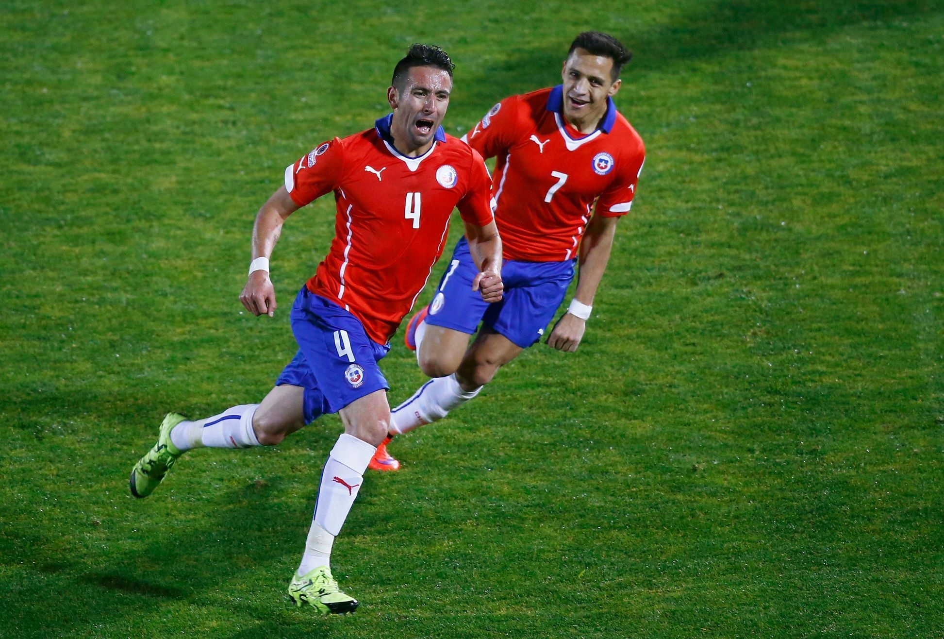 Chile's Isla celerates his goal with teammate Sanchez during their quarter-finals Copa America 2015 soccer match against Uruguay at the National Stadium in Santiago