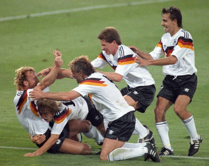 FILE PHOTO: West Germany's Brehme (L) is mobbed by teammates after he scored the only goal of the World Cup final against Argentina on a penalty kick July 8, 1990 in Rome