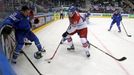 Tomas Hertl of the Czech Republic (C) chases the puck past by Italy's Nathan di Casimiro (L) during the second period of their men's ice hockey World Championship Group A