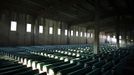 A Bosnian Muslim man prays near coffins prepared for a mass burial at the Memorial Center in Potocari, near Srebrenica July 9, 2012. The bodies of 520 recently identified victims of the Srebrenica massacre will be buried on July 11, the anniversary of the massacre when Bosnian Serb forces commanded by Ratko Mladic slaughtered 8,000 Muslim men and boys and buried them in mass graves, in Europe's worst massacre since World War Two. REUTERS/Dado Ruvic (BOSNIA - Tags: ANNIVERSARY CONFLICT POLITICS) Published: Čec. 9, 2012, 5:48 odp.