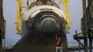 A space center technician works on the nose section of the space shuttle Discovery before it was elevated in the Mate Demate facility at Kennedy Space Center in Cape Canaveral