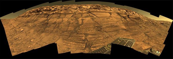 'Burns Cliff' Color Panorama NASA's Mars Exploration Rover Opportunity captured this view of "Burns Cliff" after driving right to the base of this southeastern portion of the inner wall of "Endurance Crater." The view combines frames taken by Opportunity's panoramic camera between the rover's 287th and 294th martian days (Nov. 13 to 20, 2004). This is a composite of 46 different images, each acquired in seven different Pancam filters. It is an approximately true-color rendering generated from the panoramic camera's 750-nanometer, 530-nanometer and 430-nanometer filters. The mosaic spans more than 180 degrees side to side. Because of this wide-angle view, the cliff walls appear to bulge out toward the camera. In reality the walls form a gently curving, continuous surface. Image credit: NASA/JPL/Cornell