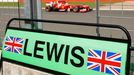 Ferrari Formula One driver Fernando Alonso of Spain drives past the pit board of Mercedes driver Lewis Hamilton of Britain during the final practice session for the Briti