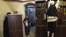 Yoel Kreus (R) reaches for a box as his daughter Esther, 13, holds her 3-week old sister during the family's preparations for the Jewish Sabbath in Jerusalem's Mea Shearim neighbourhood June 29, 2012.The Kreus family are a member of Neturei Karta, a fringe ultra-Orthodox movement within the anti-Zionist bloc. The ultra-Orthodox Jews have gone from being a tiny minority in Israel's mostly secular society to its fastest-growing sector, now about 10 percent of the 7.8 million population. They are exempt from military duty in Israel but draft deferments and state subsidies for the ultra-Orthodox have become a divisive political issue in Israel, where the government must decide a new law by August to ensure more of them do military service. Picture taken June 29, 2012. REUTERS/Ronen Zvulun (JERUSALEM - Tags: RELIGION POLITICS MILITARY) ATTENTION EDITORS - PICTURE 8 OF 21 FOR PACKAGE "ISRAEL'S ULTRA-ORTHODOX". SEARCH "ULTRA-ORTHODOX" FOR ALL PICTURES Published: Čec. 6, 2012, 10:01 dop.