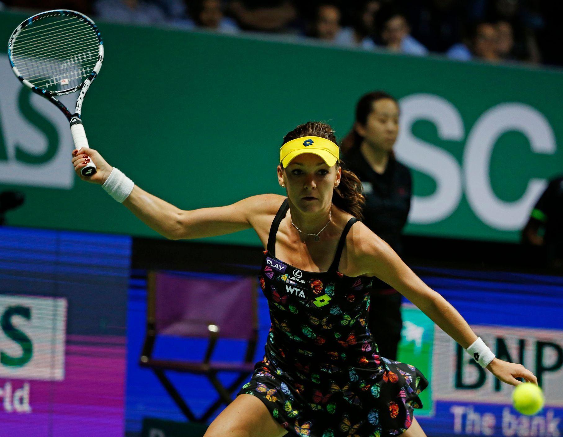 Radwanska of Poland hits a return to Kvitova of the Czech Republic during their WTA Finals singles tennis match at the Singapore Indoor Stadium