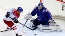 Jiri Hudler of the Czech Republic (L) challenges France's goalie Florian Hardy (R) during the third period of their men's ice hockey World Championship Group A game at Ch