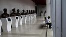 A man sits in a hallway with busts of former Chinese communist leaders at the Revolution museum in Jinggangshan, Jiangxi province, September 20, 2012. China has yet to announce the start date for the 18th Communist Party Congress, China's biggest political meeting in 10 years, which will see the transfer of power from President Hu Jintao and Premier Wen Jiabao to a new generation. REUTERS/Carlos Barria (CHINA - Tags: POLITICS) Published: Zář. 20, 2012, 4:43 odp.