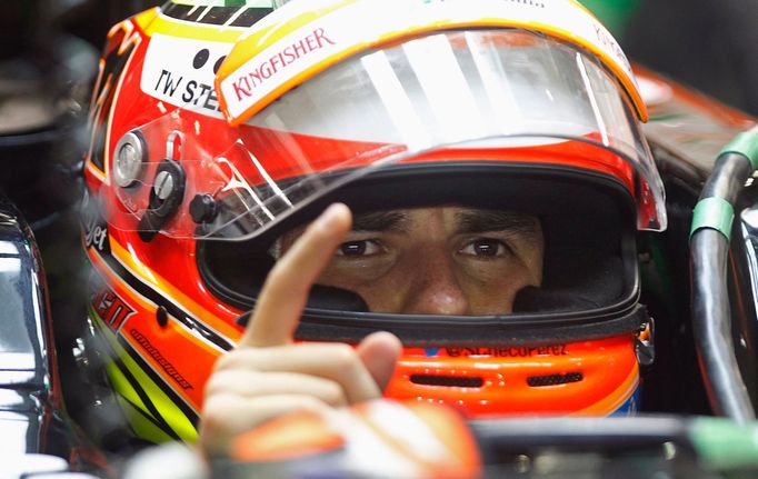 Force India Formula One driver Sergio Perez of Mexico gestures in his car during the second practice session of the Singapore F1 Grand Prix at the Marina Bay street circu