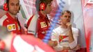 Ferrari Formula One driver Sebastian Vettel of Germany (R) reacts in the team garage during the third practice session of the Australian F1 Grand Prix at the Albert Park