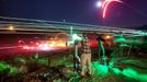 Gun Enthusiasts Gather for Machine Gun Shoot in Rural Arizona 2012-10-19 00:00:00 epa03514996 (16/22) A long exposure image shows a visitor to the Big Sandy Machine Gun Shoot firing his machine gun as flares, tracer fire, and the moon light up the night sky outside Wikieup, Arizona, USA, 19 October 2012. Twice a year, the Big Sandy lures gun enthusiasts to the Sonoran Desert for a weekend of firing heavy weaponry. EPA/JIM LO SCALZO