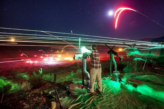 Gun Enthusiasts Gather for Machine Gun Shoot in Rural Arizona 2012-10-19 00:00:00 epa03514996 (16/22) A long exposure image shows a visitor to the Big Sandy Machine Gun Shoot firing his machine gun as flares, tracer fire, and the moon light up the night sky outside Wikieup, Arizona, USA, 19 October 2012. Twice a year, the Big Sandy lures gun enthusiasts to the Sonoran Desert for a weekend of firing heavy weaponry. EPA/JIM LO SCALZO