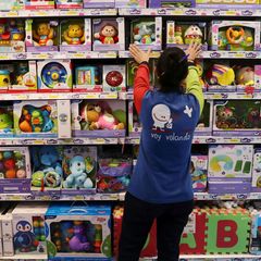 FILE PHOTO: A worker arranges toy boxes inside a Jugettos's toy shop in Madrid