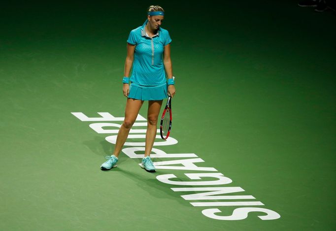 Petra Kvitova of the Czech Republic reacts after losing a point against Agnieszka Radwanska of Poland during their WTA Finals singles tennis match at the Singapore Indoor