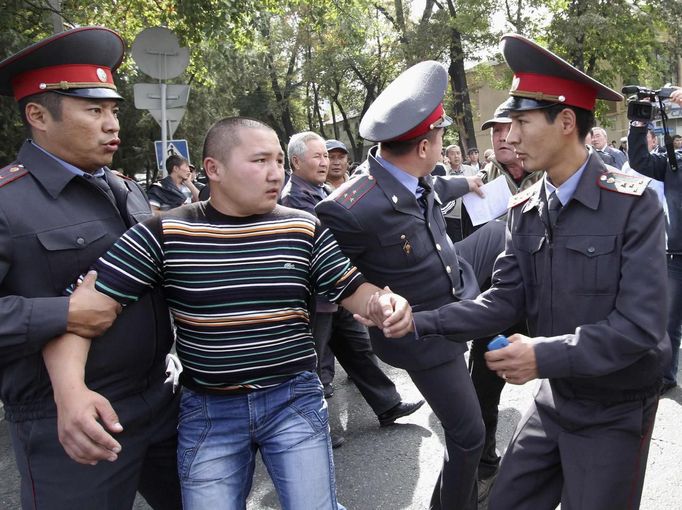 Kyrgyzští policisté odvádějí jednoho z demonstrantů.