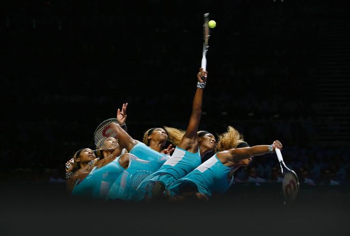 Serena Williams of the U.S. serves against Caroline Wozniacki of Denmark during their WTA Finals singles semi-final tennis match at the Singapore Indoor Stadium October 2