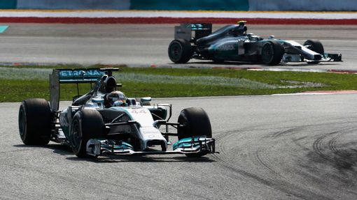 Mercedes Formula One driver Lewis Hamilton of Britain drives ahead of team mate Nico Rosberg of Germany during the Malaysian F1 Grand Prix at Sepang International Circuit
