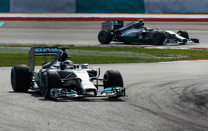 Mercedes Formula One driver Lewis Hamilton of Britain drives ahead of team mate Nico Rosberg of Germany during the Malaysian F1 Grand Prix at Sepang International Circuit