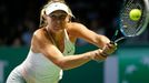 Maria Sharapova of Russia hits a return to Petra Kvitova of the Czech Republic during their WTA Finals singles tennis match at the Singapore Indoor Stadium October 23, 20