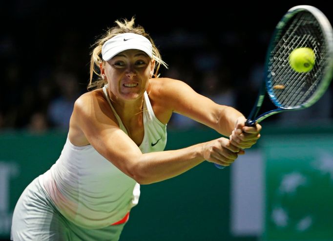 Maria Sharapova of Russia hits a return to Petra Kvitova of the Czech Republic during their WTA Finals singles tennis match at the Singapore Indoor Stadium October 23, 20