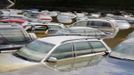 Cars emerge from the subsiding floods of the Danube river at a car dealership in Fischerdorf, a suburb of the eastern Bavarian city of Deggendorf June 10, 2013. Tens of thousands of Germans, Hungarians and Czechs were evacuated from their homes on Wednesday as soldiers raced to pile up sandbags to hold back rising waters in the region's worst floods in a decade. REUTERS/Wolfgang Rattay (GERMANY - Tags: POLITICS DISASTER)