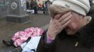 ATTENTION EDITORS - VISUAL COVERAGE OF SCENES OF INJURY OR DEATH - A woman reacts as dead bodies are seen on the ground following violence in Independence Square in Kiev