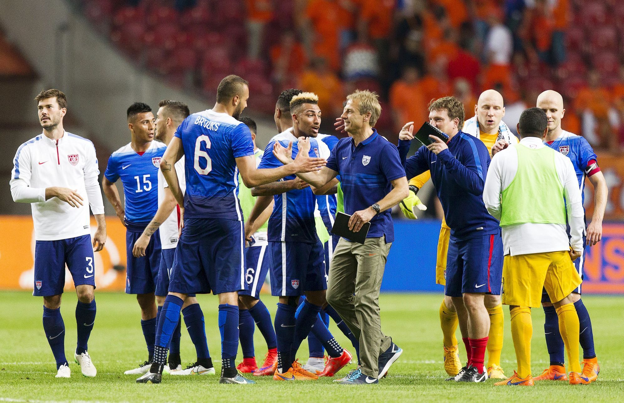 Team U.S. celebrate victory over Netherlands with coach Jurgen Klinsmann after friendly soccer match at Amsterdam Arena