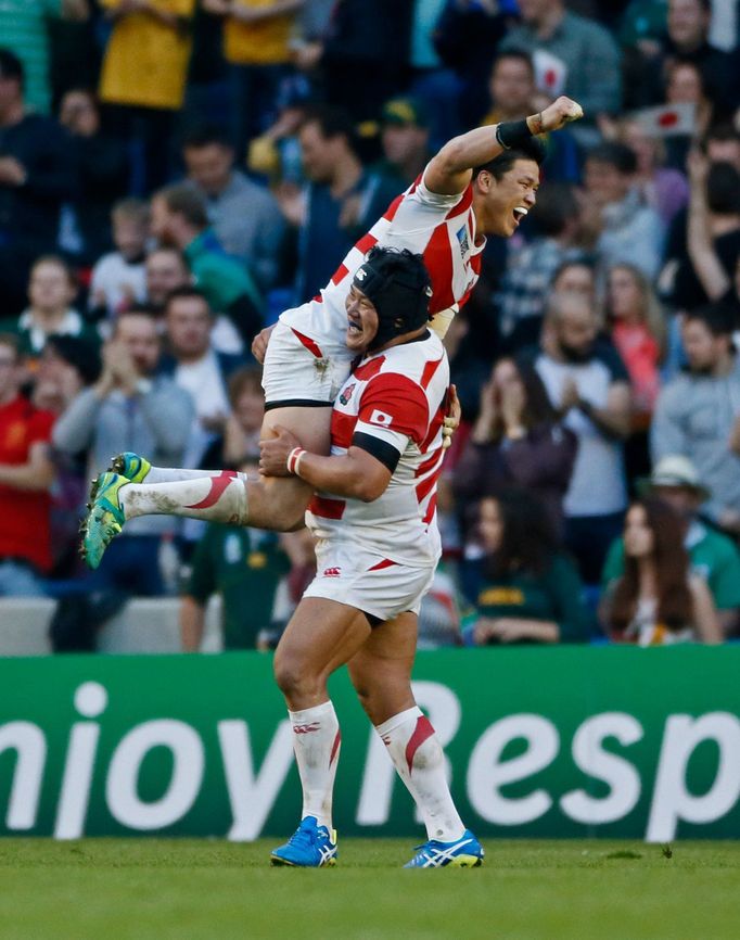 Japan's Harumichi Tatekawas (top) celebrates Karne Hesketh's winning try Reuters / Stefan Wermuth Livepic