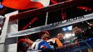 Manny Pacquiao of the Philippines prays in the ring under a Philippines national flag before his World Boxing Organisation (WBO) 12-round welterweight title fight against