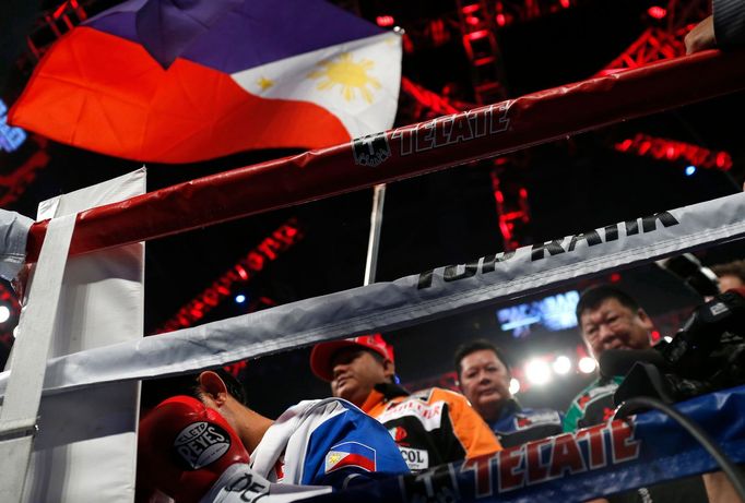 Manny Pacquiao of the Philippines prays in the ring under a Philippines national flag before his World Boxing Organisation (WBO) 12-round welterweight title fight against