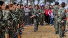 A female fighter of the Kurdish People's Protection Units (YPG) goes back to her place after receiving her military card at a military camp in Ras a-Ain, January 30, 2015