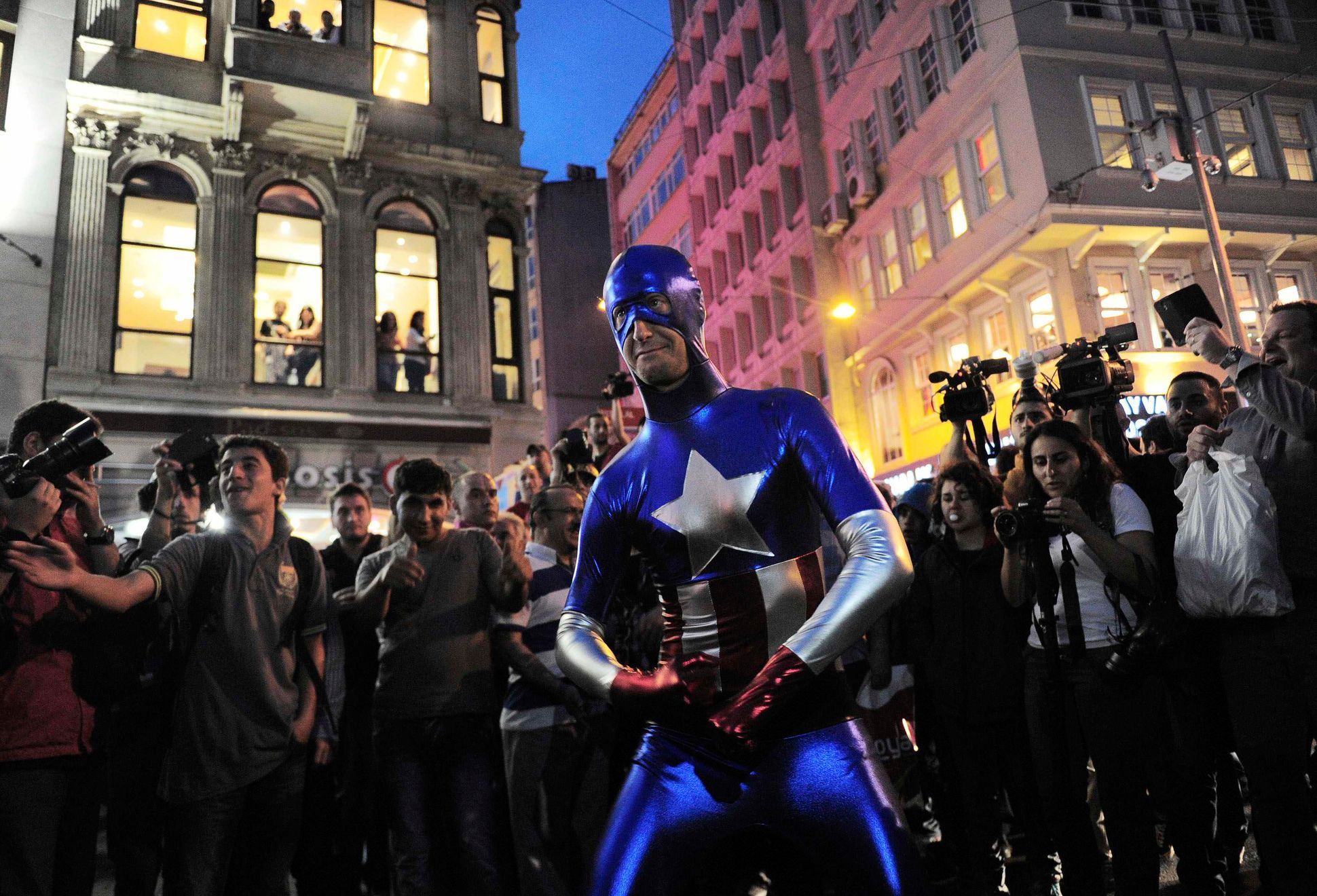 A man wearing a Captain America costume performs following an anti-government protest in Istanbul