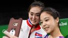 Lee Goim (KOR) of South Korea (R) takes a selfie picture with Hong Un Jong (PRK) of North Korea.