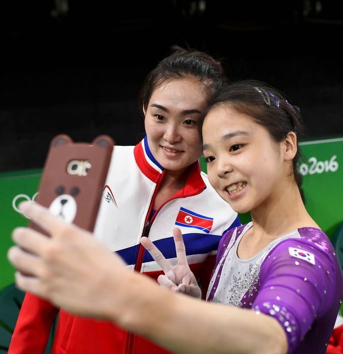 Lee Goim (KOR) of South Korea (R) takes a selfie picture with Hong Un Jong (PRK) of North Korea.