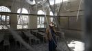 A boy stands in a classroom at his school after it was hit by a Saudi-led air strike in Yemen's capital Sanaa July 20, 2015.