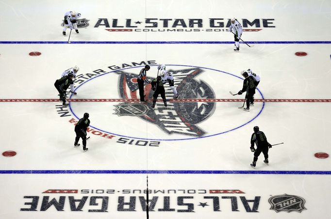 Jan 25, 2015; Columbus, OH, USA; Team Toews center Jonathan Toews (19) of the Chicago Blackhawks takes a face off against Team Foligno center Zemgus Girgensons (28) of th