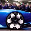 Renault's Chief Executive Luca De Meo gestures as he speaks with French President Emmanuel Macron at the 2022 Paris Auto Show, in Paris, France, October 17, 2022. REUTERS