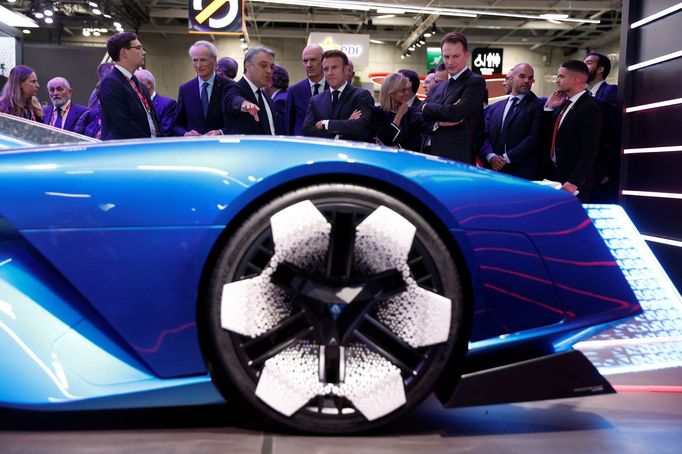 Renault's Chief Executive Luca De Meo gestures as he speaks with French President Emmanuel Macron at the 2022 Paris Auto Show, in Paris, France, October 17, 2022. REUTERS