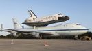 Space shuttle Discovery is shown attached to a modified NASA 747 aircraft at Kennedy Space Center in Cape Canaveral