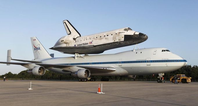 Space shuttle Discovery is shown attached to a modified NASA 747 aircraft at Kennedy Space Center in Cape Canaveral