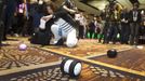 A woman takes a photo of a Sphero 2.0 by Orbotix during &quot;CES Unveiled,&quot; a media preview event to the annual Consumer Electronics Show (CES), in Las Vegas, Nevad