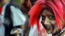 A zombie waits to chase runners at the "Run for Your Lives" 5K obstacle course race in Amesbury, Massachusetts May 5, 2012. Runners face man-made and natural obstacles on the course, while being chased by zombies, who try to take "health" flags off the runners belts. REUTERS/Brian Snyder (UNITED STATES - Tags: SPORT SOCIETY) Published: Kvě. 5, 2012, 11:17 odp.